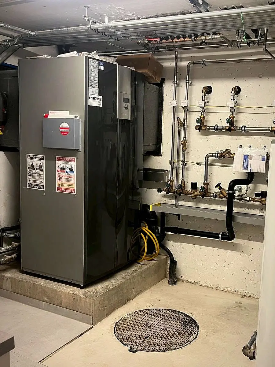 Indoor air-to-water heat pump installed by Agrotherm in a house in Nyon