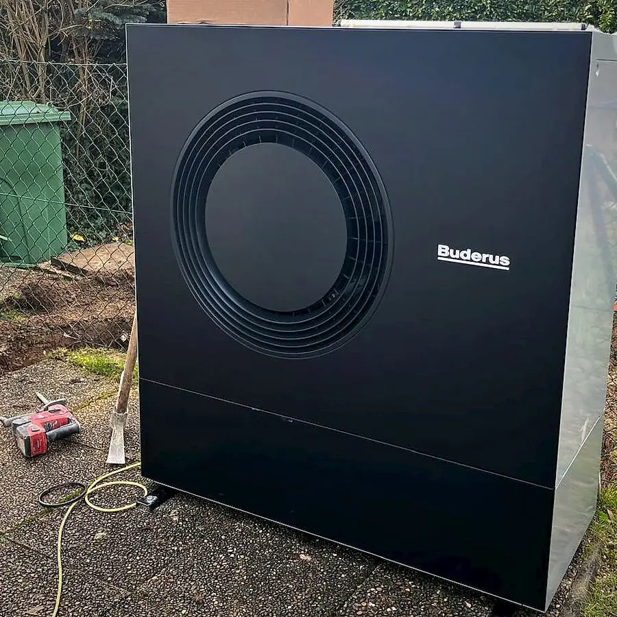 Air-to-water heat pump installed in a garden in Founex